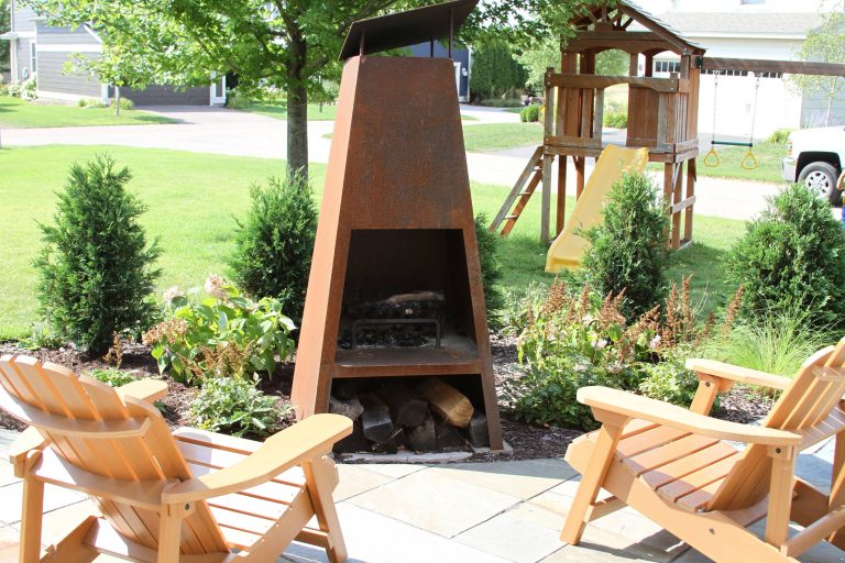 Example of a mid-sized trendy front yard stone patio kitchen design in Minneapolis with no cover