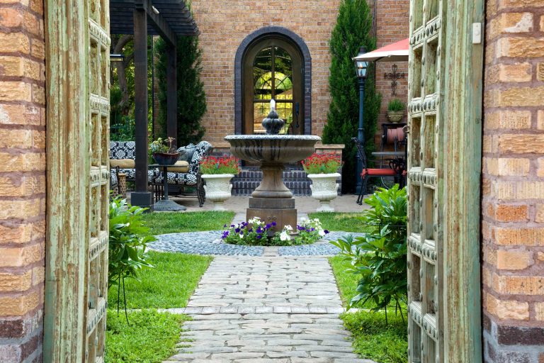 Example of a mid-sized tuscan backyard brick patio kitchen design in Denver with a pergola