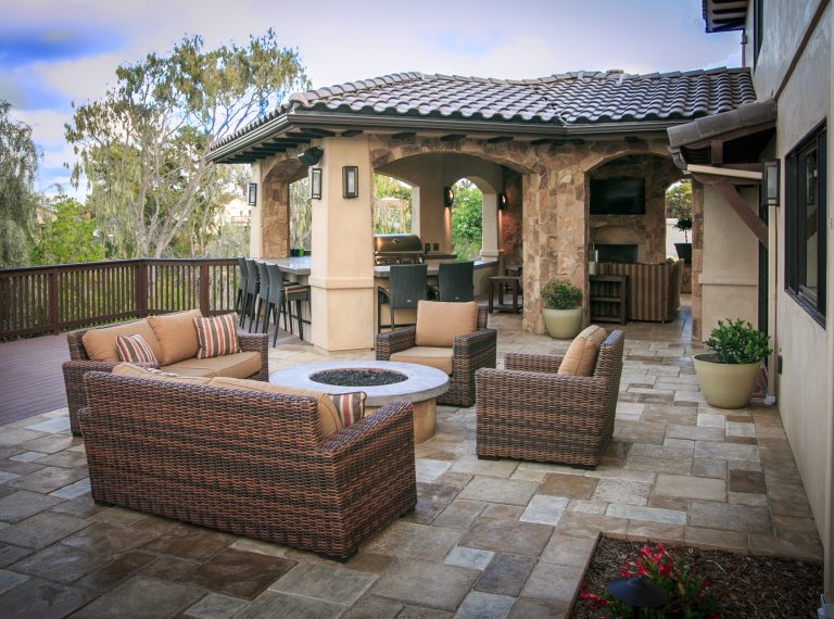 Example of a mid-sized tuscan backyard concrete paver patio kitchen design in San Diego with a roof extension