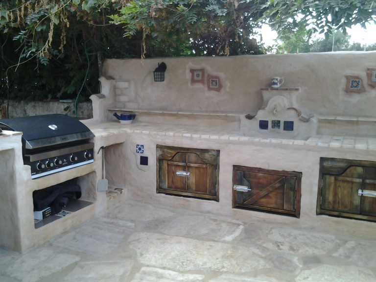 Example of a mid-sized tuscan backyard tile patio kitchen design in Los Angeles with no cover