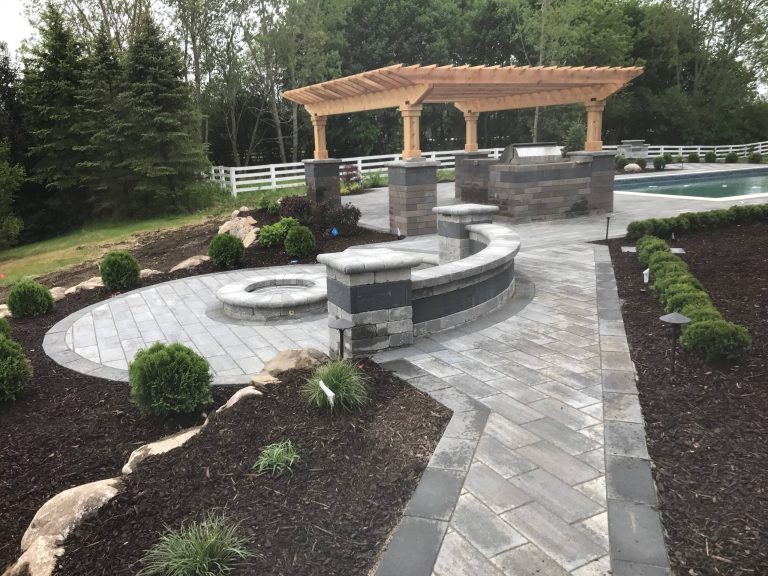 Example of a minimalist backyard brick patio kitchen design in Detroit with a pergola