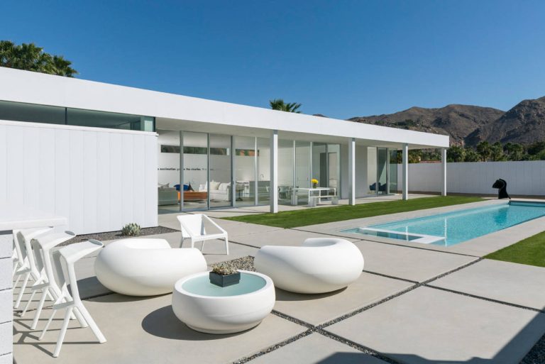 Example of a minimalist backyard rectangular and concrete paver pool design in Los Angeles