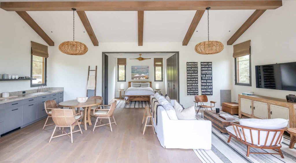 Example of a minimalist backyard stone and rectangular pool house design in Santa Barbara