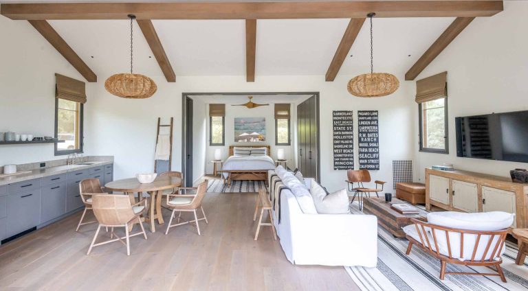 Example of a minimalist backyard stone and rectangular pool house design in Santa Barbara