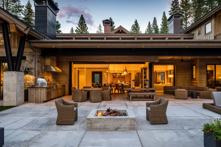 Example of a mountain style backyard concrete patio kitchen design in Sacramento with no cover