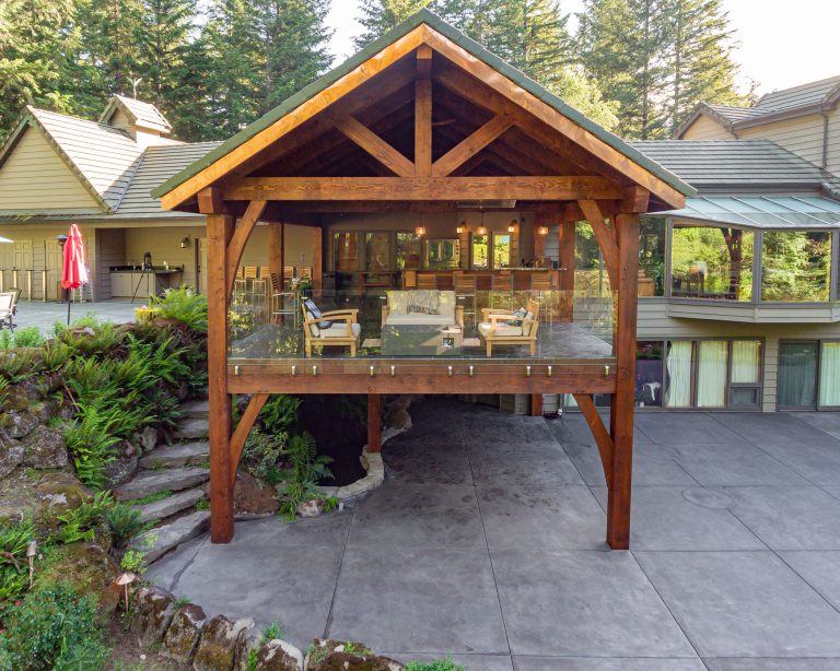 Example of a mountain style backyard outdoor kitchen deck design in Portland