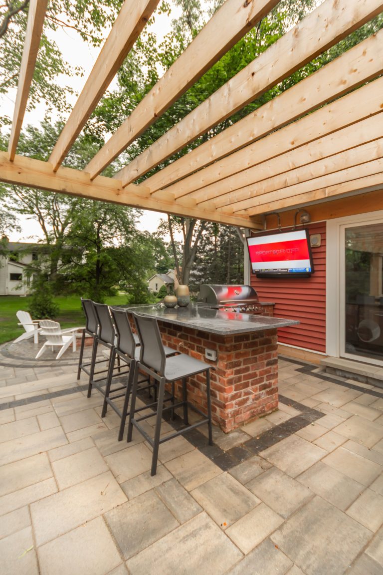 Example of a small arts and crafts backyard brick patio kitchen design in Detroit with a pergola