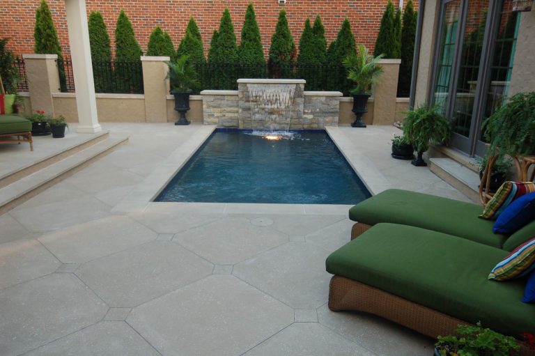 Example of a small arts and crafts courtyard concrete paver and rectangular lap pool fountain design in Other