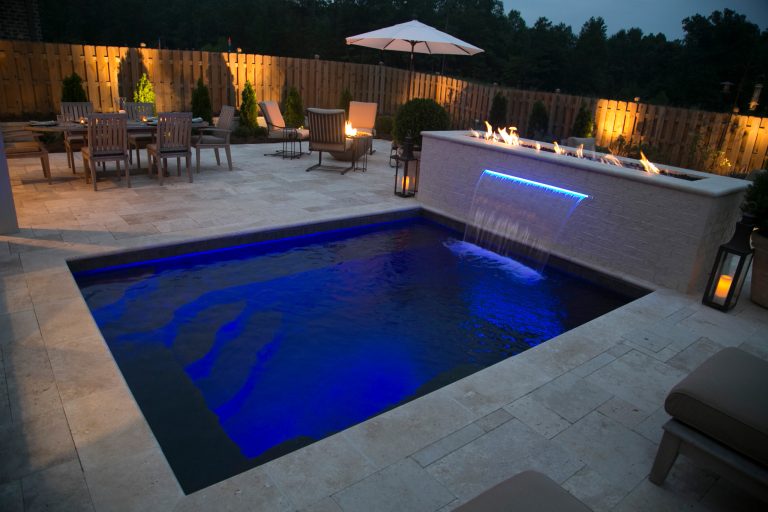 Example of a small backyard stone and rectangular pool design in Birmingham