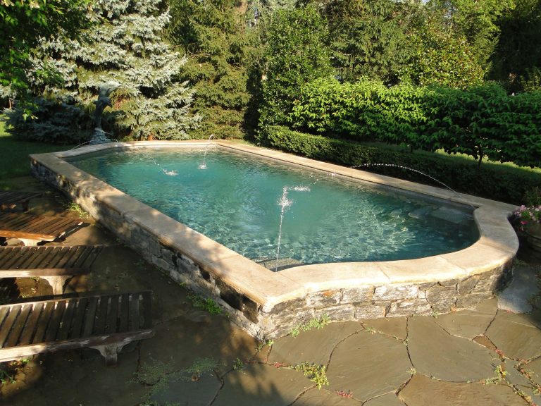 Example of a small classic backyard stone and custom-shaped pool fountain design in Philadelphia