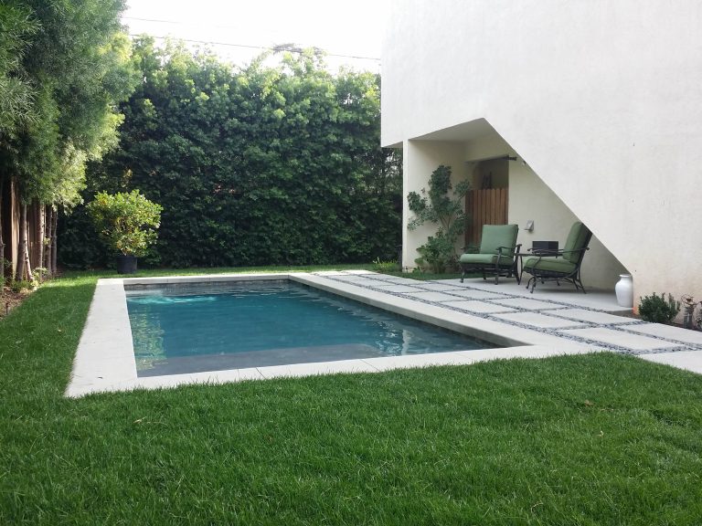 Example of a small minimalist backyard concrete paver and rectangular lap pool design in Los Angeles