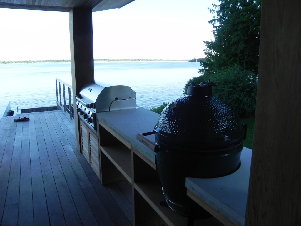 Example of a small minimalist backyard outdoor kitchen deck design in Burlington