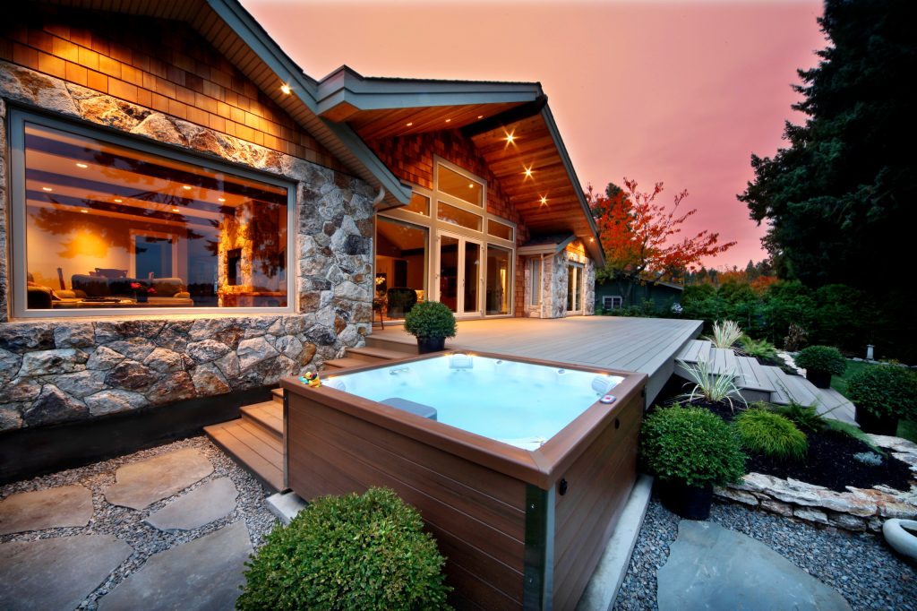 Example of a small mountain style backyard rectangular aboveground hot tub design in Tampa with decking