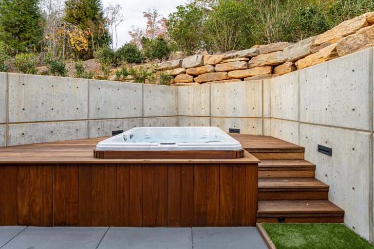 Example of a small trendy backyard stamped concrete pool design in Other