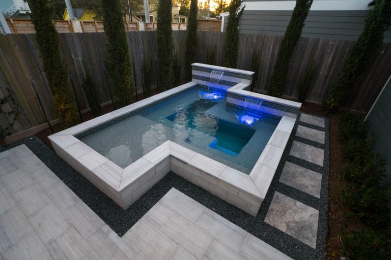 Example of a small trendy courtyard stone and rectangular hot tub design in Houston