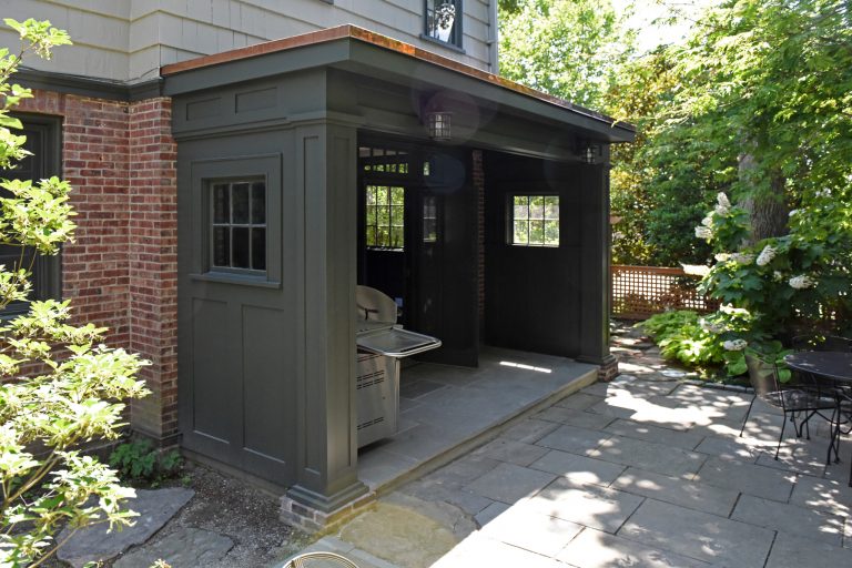 Example of a small trendy stone patio kitchen design in Providence with a gazebo