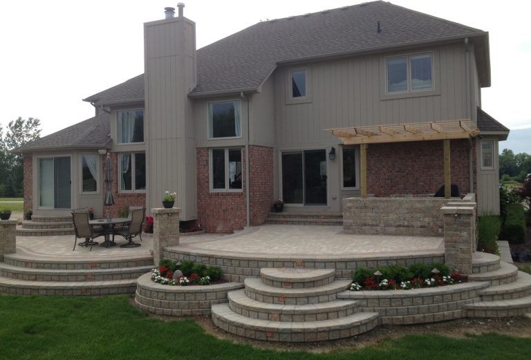 Example of a transitional backyard brick patio kitchen design in Detroit with a pergola