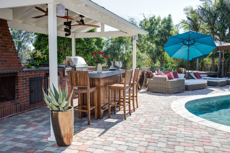 Example of a transitional backyard brick patio kitchen design in Los Angeles with a gazebo