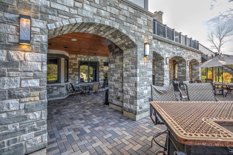 Example of a transitional backyard concrete paver patio kitchen design in Chicago with a roof extension
