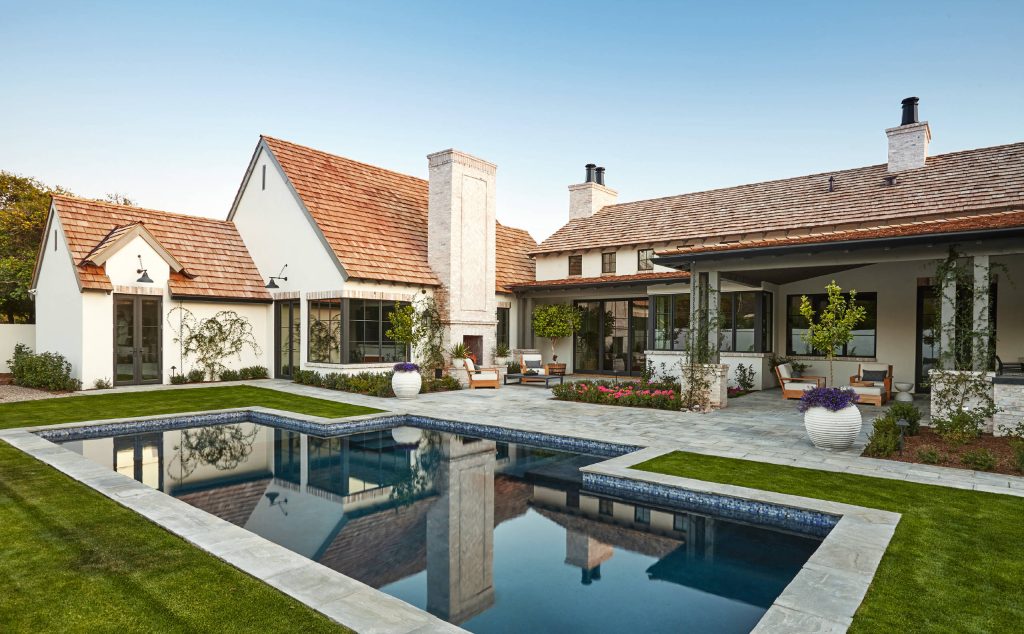 Example of a transitional backyard custom-shaped lap pool design in Phoenix