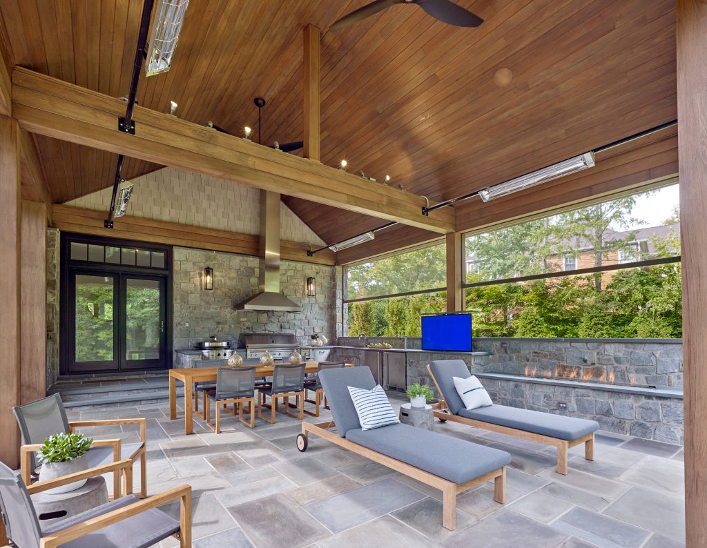 Example of a transitional backyard patio kitchen design in Other with a roof extension