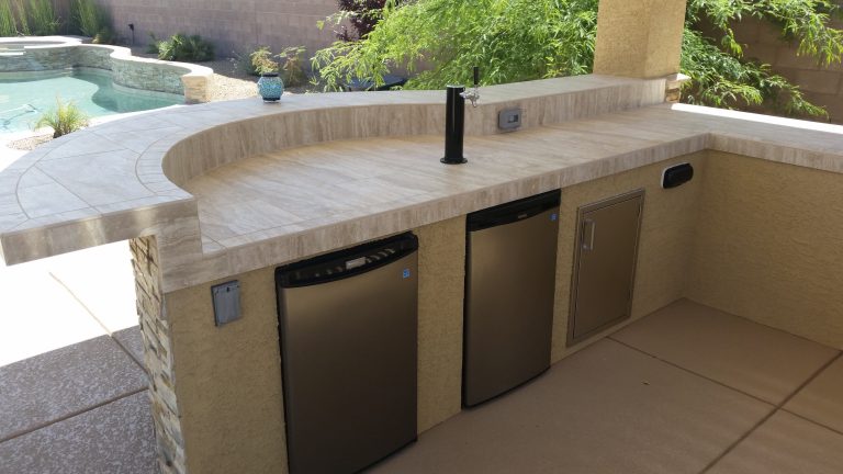 Example of a transitional backyard stone patio kitchen design in Las Vegas