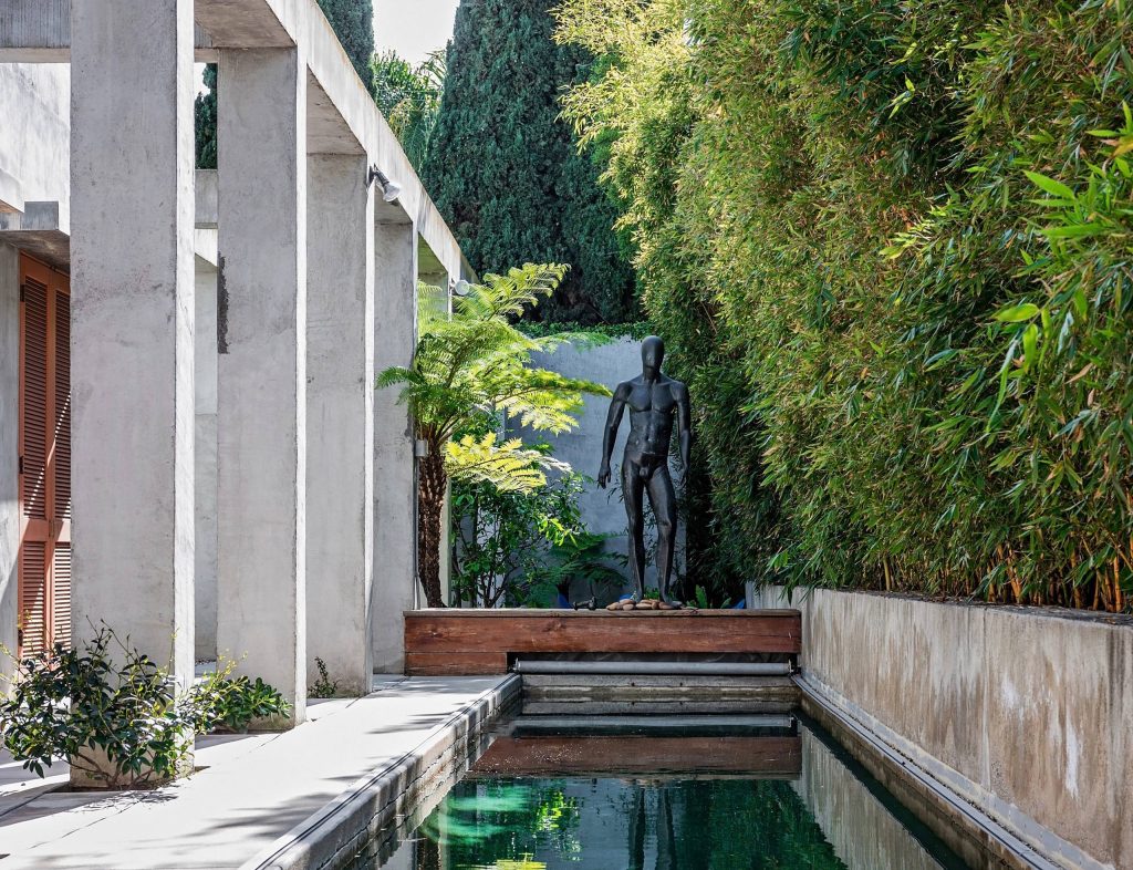 Example of a trendy backyard concrete and rectangular lap pool design in Los Angeles