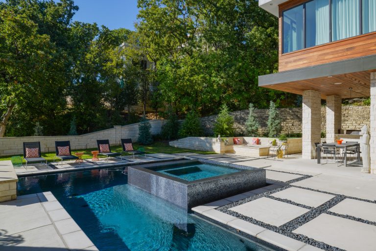 Example of a trendy backyard concrete paver and custom-shaped hot tub design in Dallas