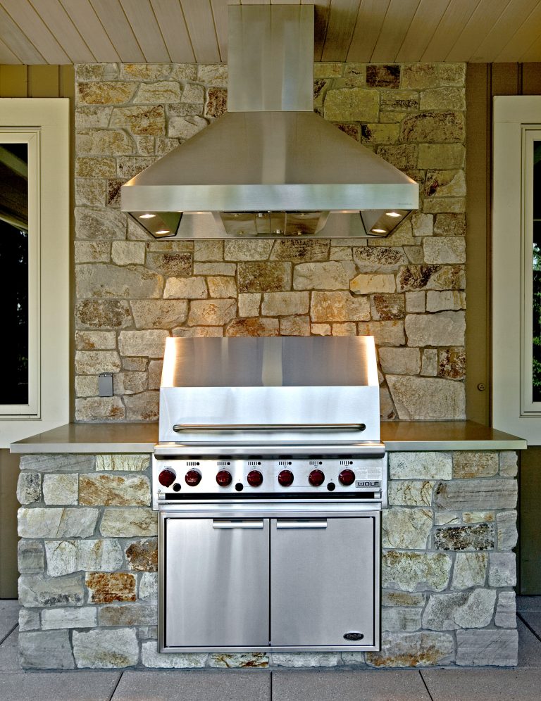 Example of a trendy backyard concrete paver patio kitchen design in Seattle with a roof extension