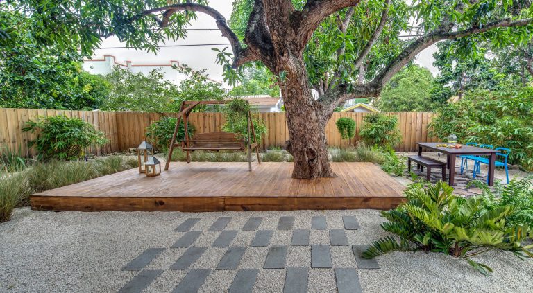 Example of a trendy backyard deck design in Miami with no cover