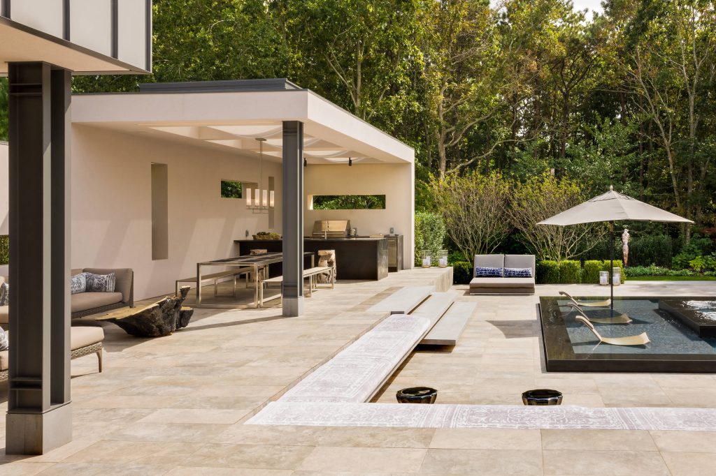 Example of a trendy backyard patio kitchen design in New York with a roof extension