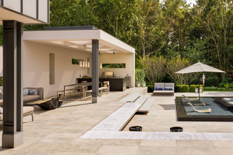 Example of a trendy backyard patio kitchen design in New York with a roof extension