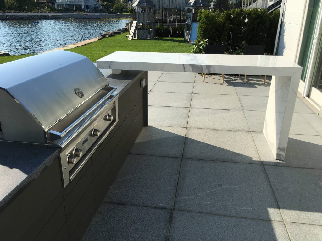 Example of a trendy backyard patio kitchen design in New York with no cover