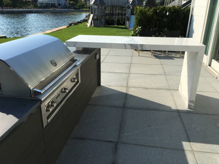 Example of a trendy backyard patio kitchen design in New York with no cover