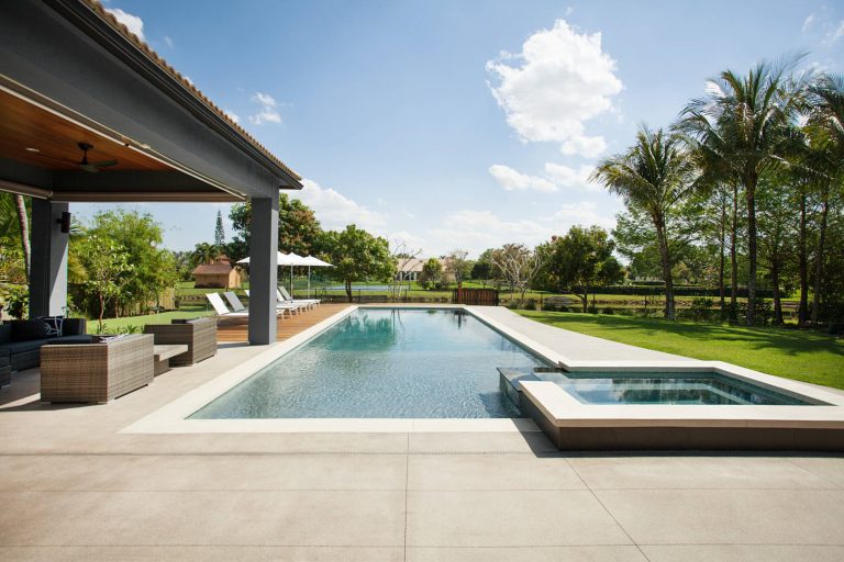 Example of a trendy backyard rectangular pool design in Miami