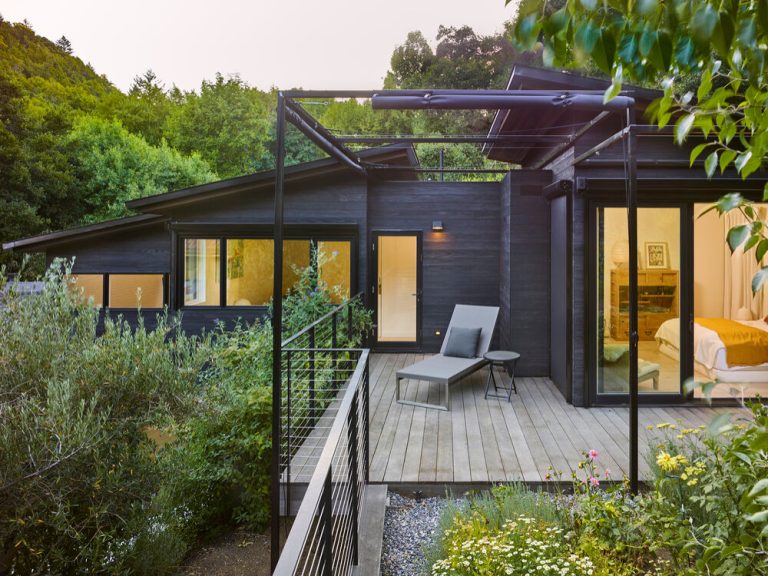 Example of a trendy cable railing deck design in San Francisco with a pergola