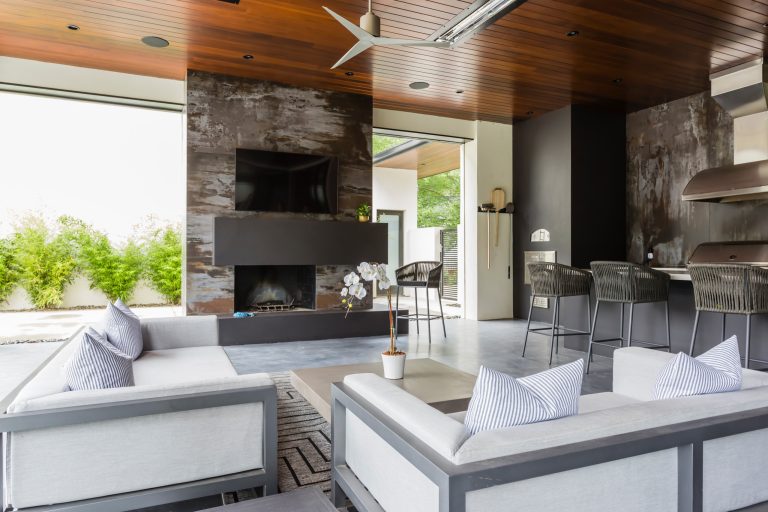 Example of a trendy concrete patio kitchen design in Raleigh with a roof extension