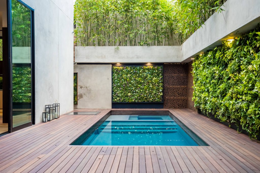 Example of a trendy courtyard rectangular hot tub design in Los Angeles with decking
