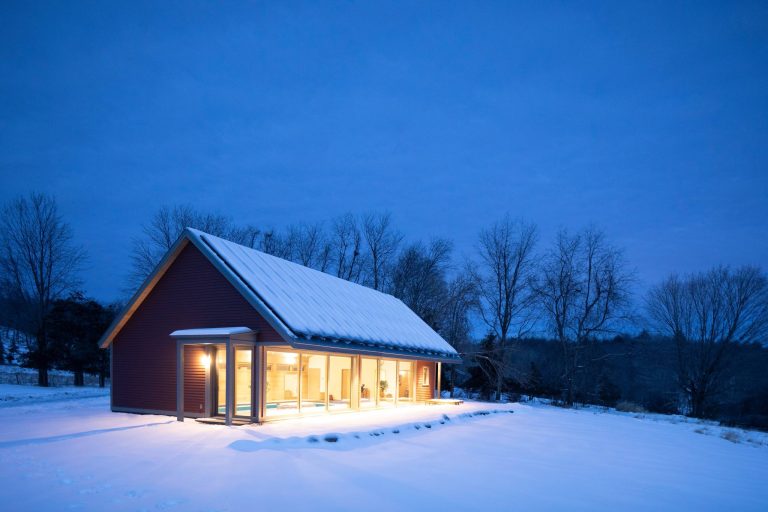 Example of a trendy indoor stone and rectangular lap pool house design in New York