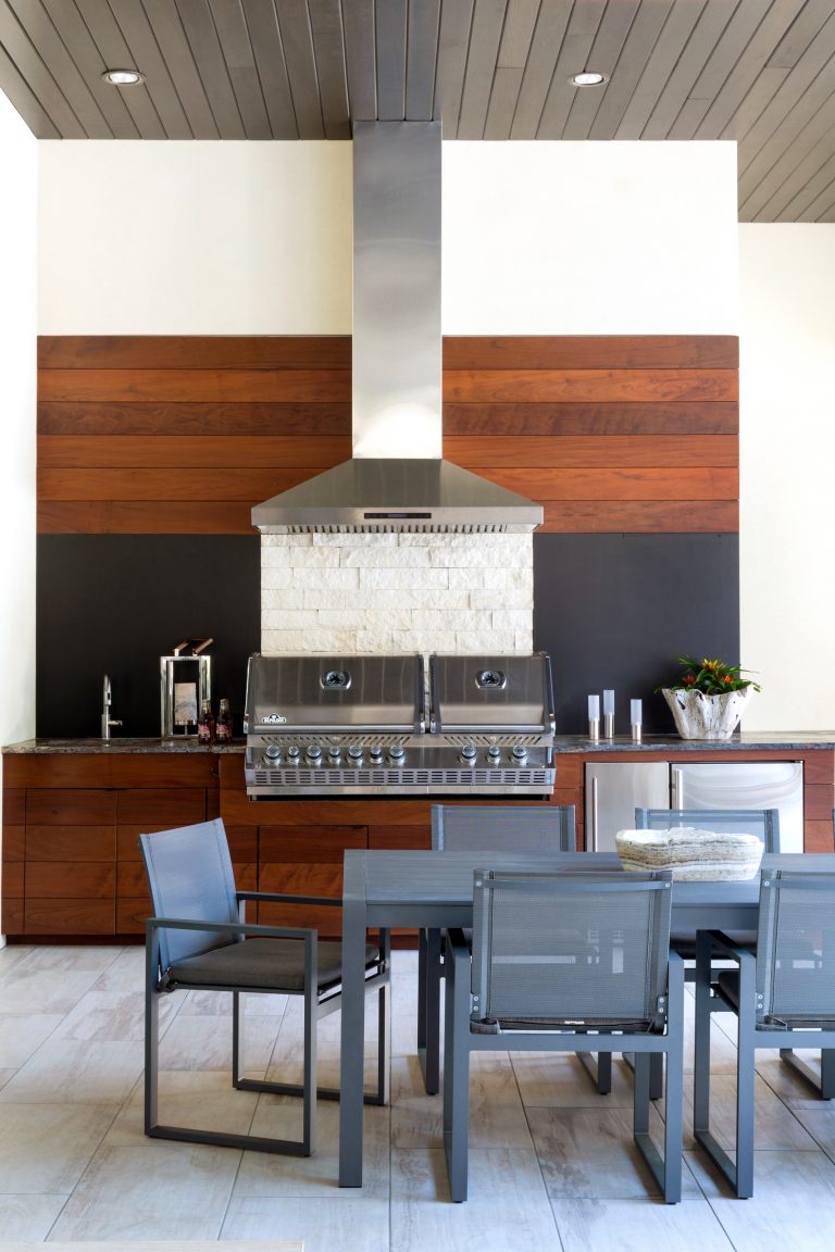 Example of a trendy tile patio kitchen design in Little Rock with a roof extension