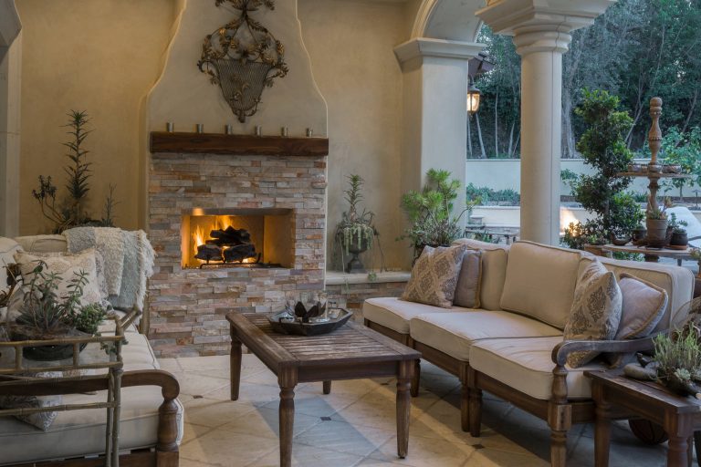 Example of a tuscan backyard decomposed granite patio kitchen design in Los Angeles with an awning