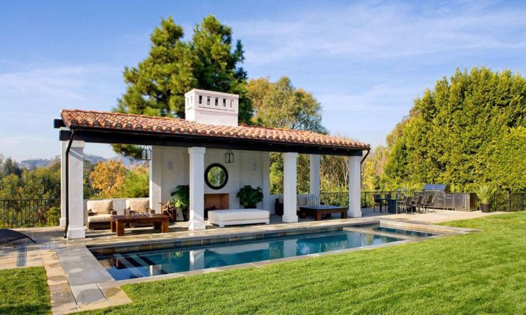 Example of a tuscan backyard rectangular lap hot tub design in Los Angeles