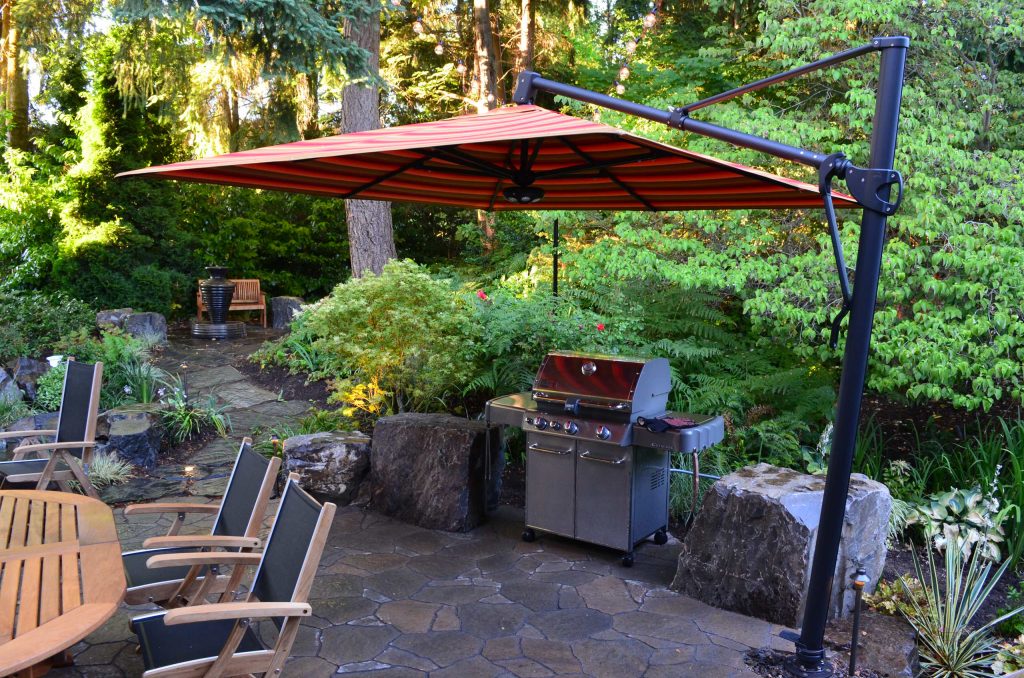 Example of an arts and crafts tile patio kitchen design in Seattle with an awning