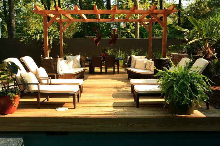 Example of an island style deck design in Atlanta with a pergola