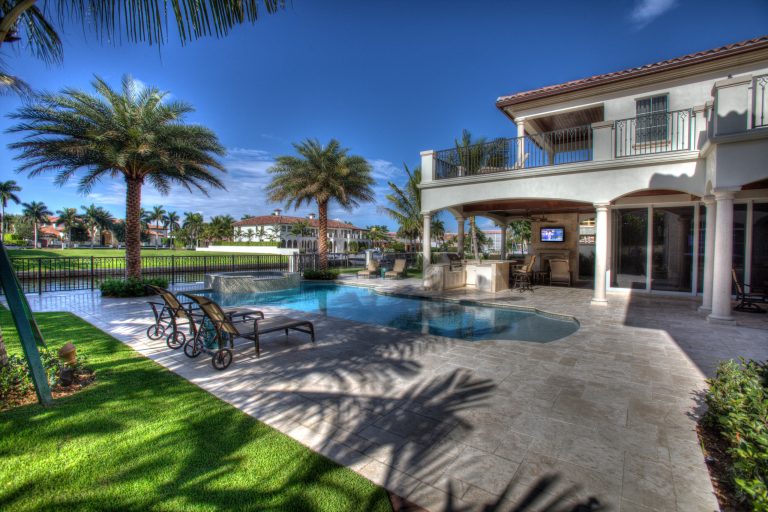 Expansive Outdoor Living space features pool, loggia, TV and surround sound. Photo by Harry Cohen