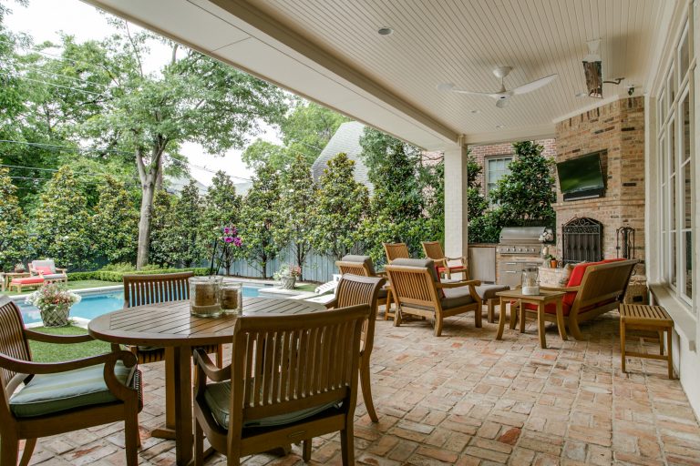Expansive back porch with fireplace and multiple seating areas