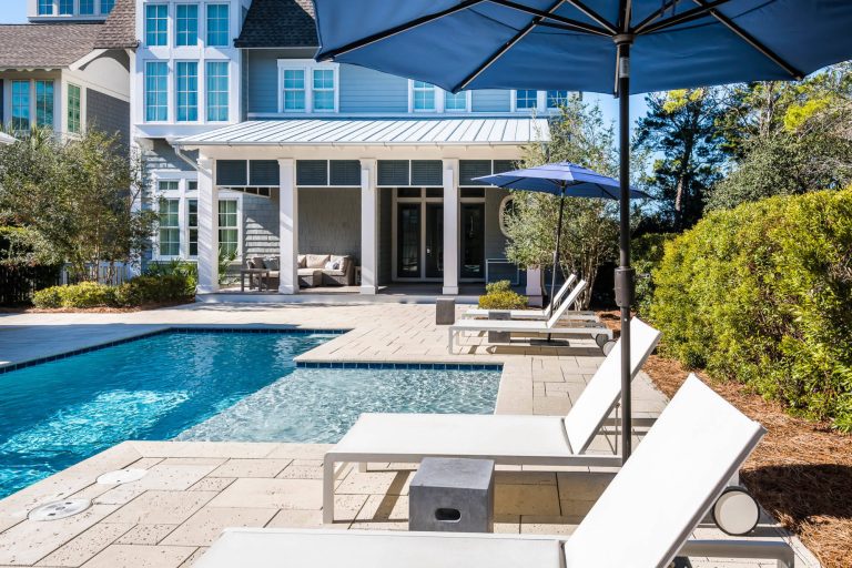 Expansive pool deck courtyard with a summer kitchen and pergola to enjoy alfresco dining year round.