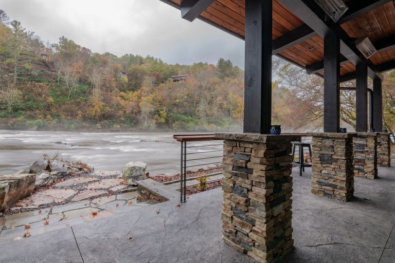 Expansive windows provide almost unbroken views of the Hiwassee river .