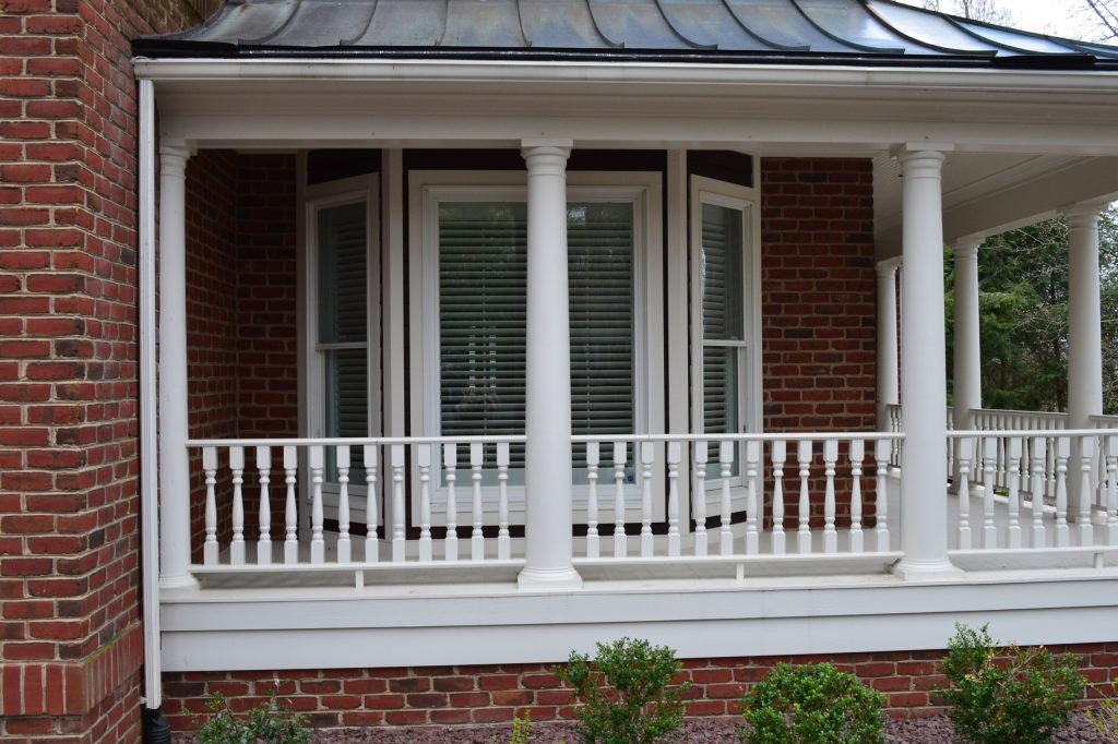 Exterior view of home with interior white wood shutters installed