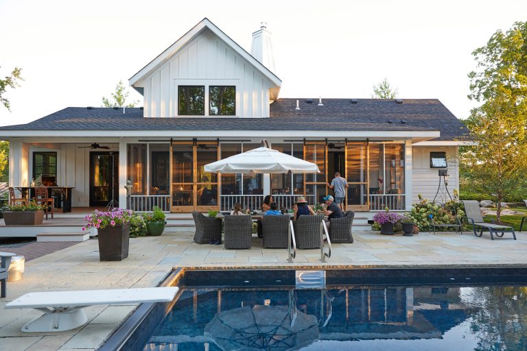 Farmhouse remodel after house fire. This home was over 100+ years old and was recently lost in a house fire which required a pool, patio, and surrounding gardens to be remodeled. by yardscapes Inc. | Outdoor Kitchens | Backyard Design | Outdoor Living Spaces | Landscape Design